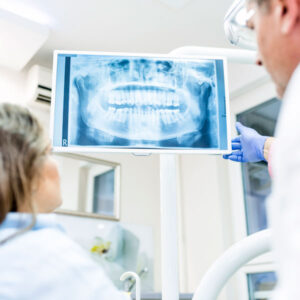 doctor showing x-ray to patient in preparation for wisdom tooth extraction in Savage, MN