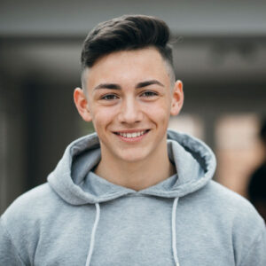 young male smiling after Wisdom Tooth Extraction in Apple Valley, Savage, MN, Burnsville, Shakopee, Eagan, and Lakeville, MN