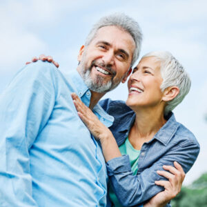 Elderly Couple Hugging and Smiling After Getting Dental Surgery in Apple Valley, Savage, MN, Lakeville, MN, Owatonna, Burnsville, Eagan